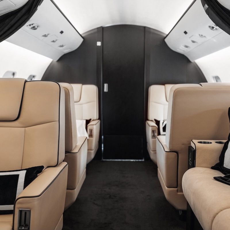 Business jet plane interior with leather comfortable seats. Private airplane transfer