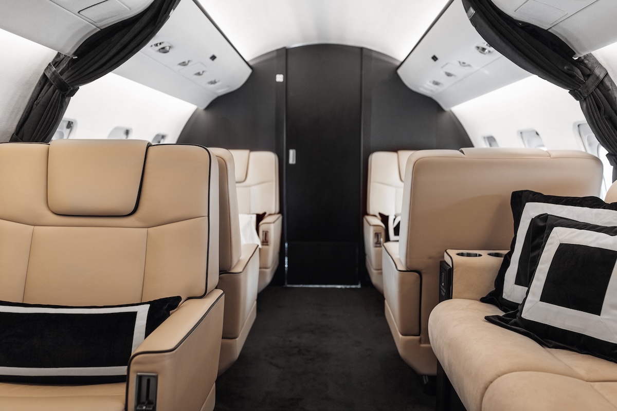 Business jet plane interior with leather comfortable seats. Private airplane transfer